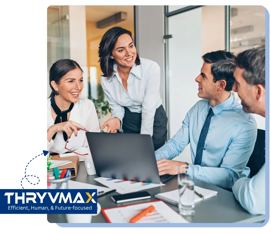 Thryvmax team discussing work around a laptop